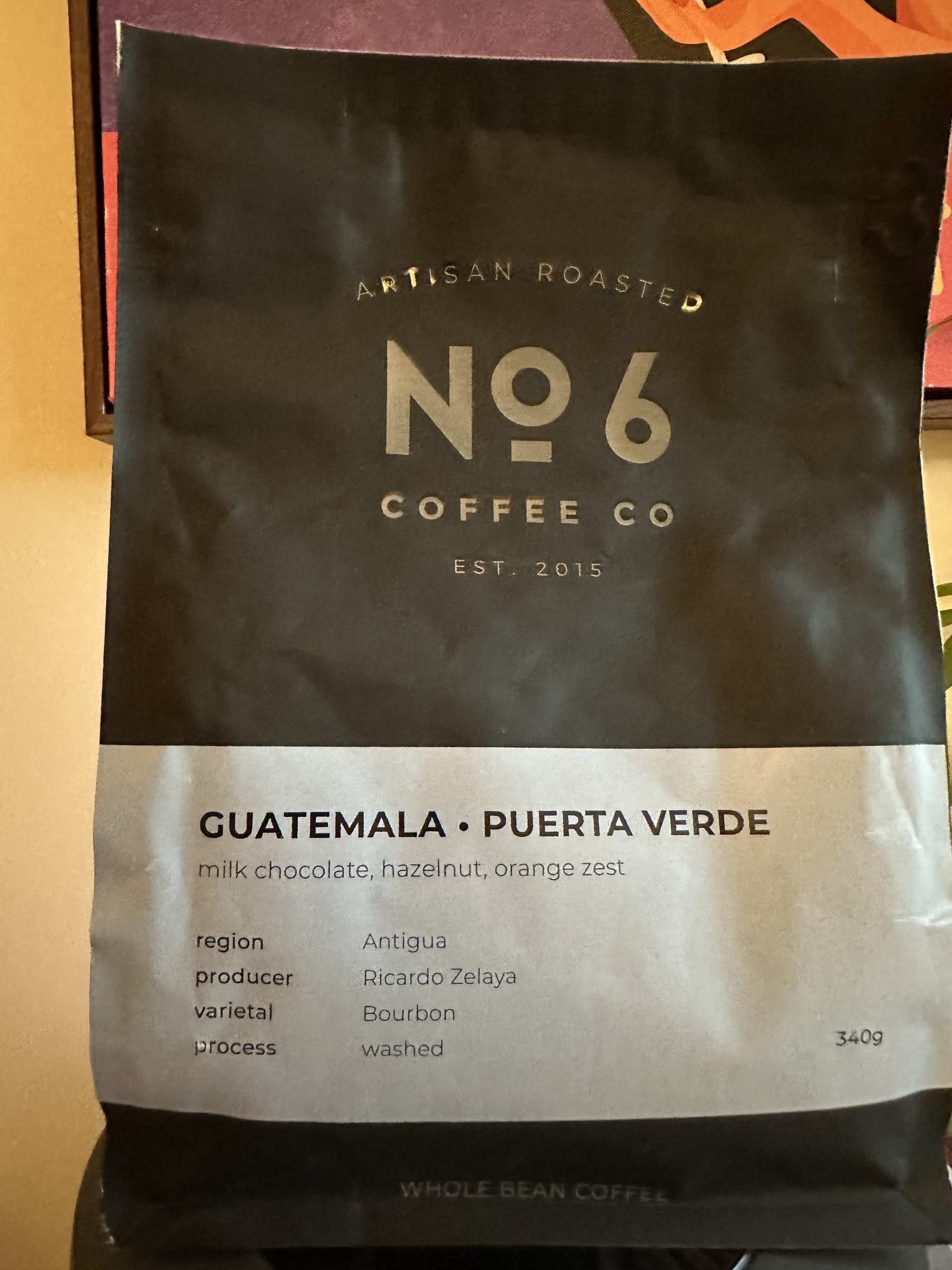 A bag of No. 6 Coffee Co. featuring Guatemalan Puerta Verde beans with notes of milk chocolate, hazelnut, and orange zest.