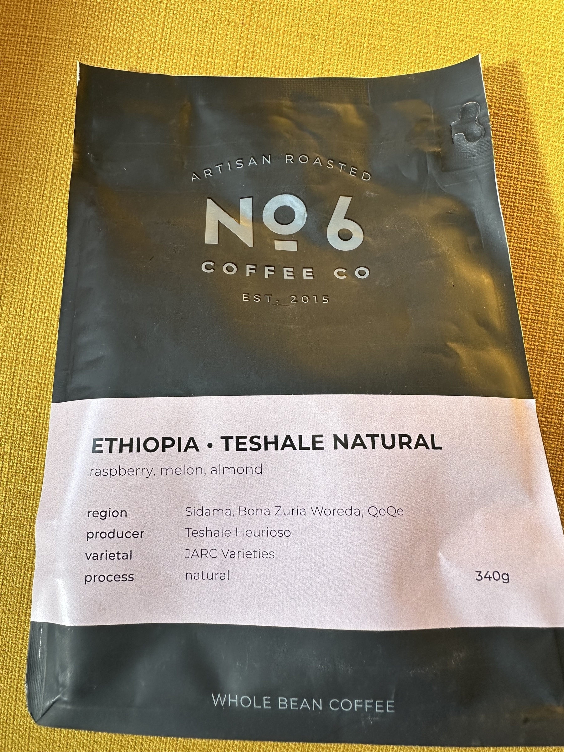 A package of artisan roasted whole bean coffee from No. 6 Coffee Co., featuring Ethiopian Teshale Natural coffee with flavor notes of raspberry, melon, and almond.