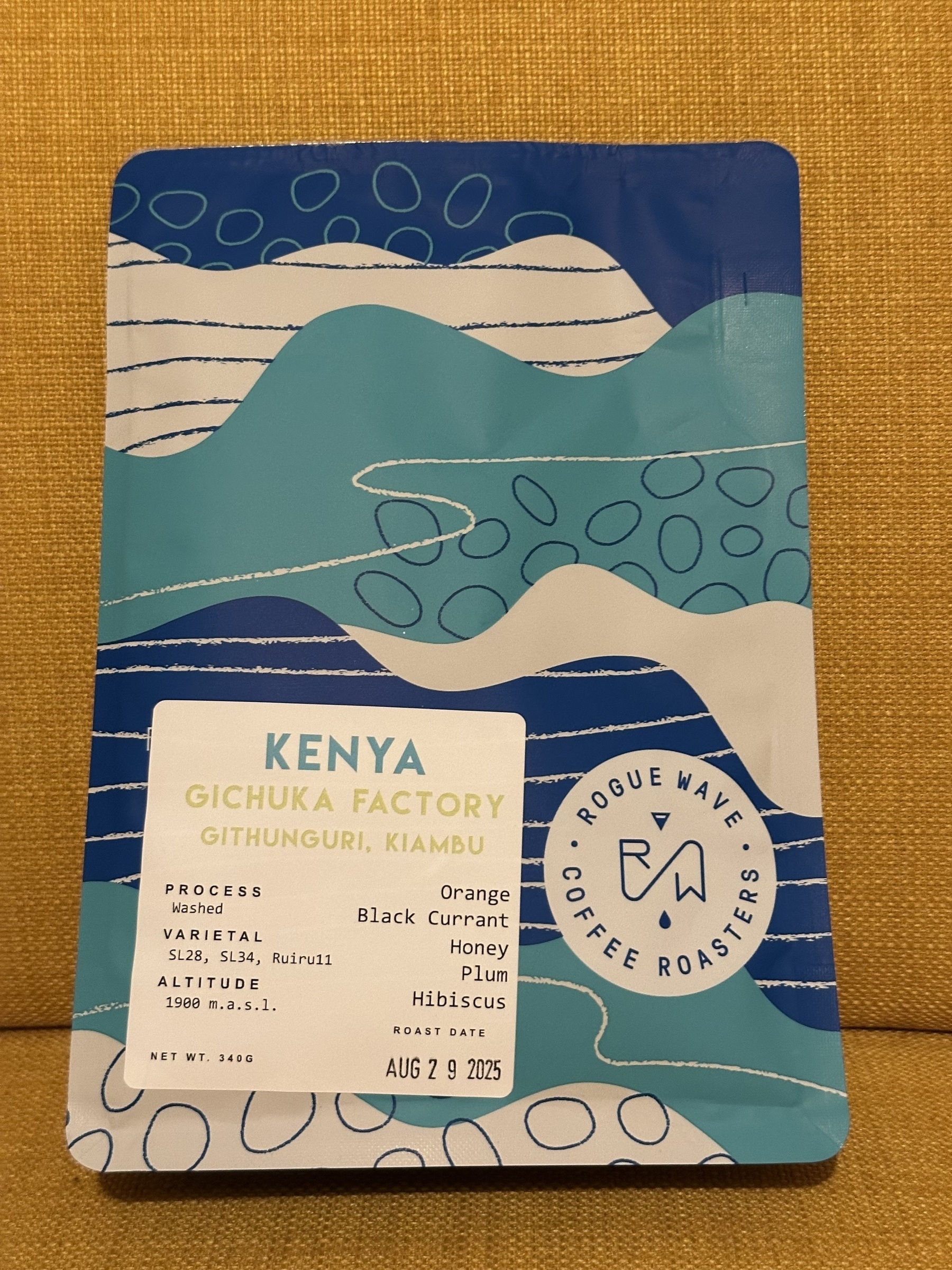 A package of Rogue Wave Coffee Roasters featuring coffee details from Kenya's Gichuka Factory, including flavour notes of orange, black currant, honey, plum, and hibiscus.