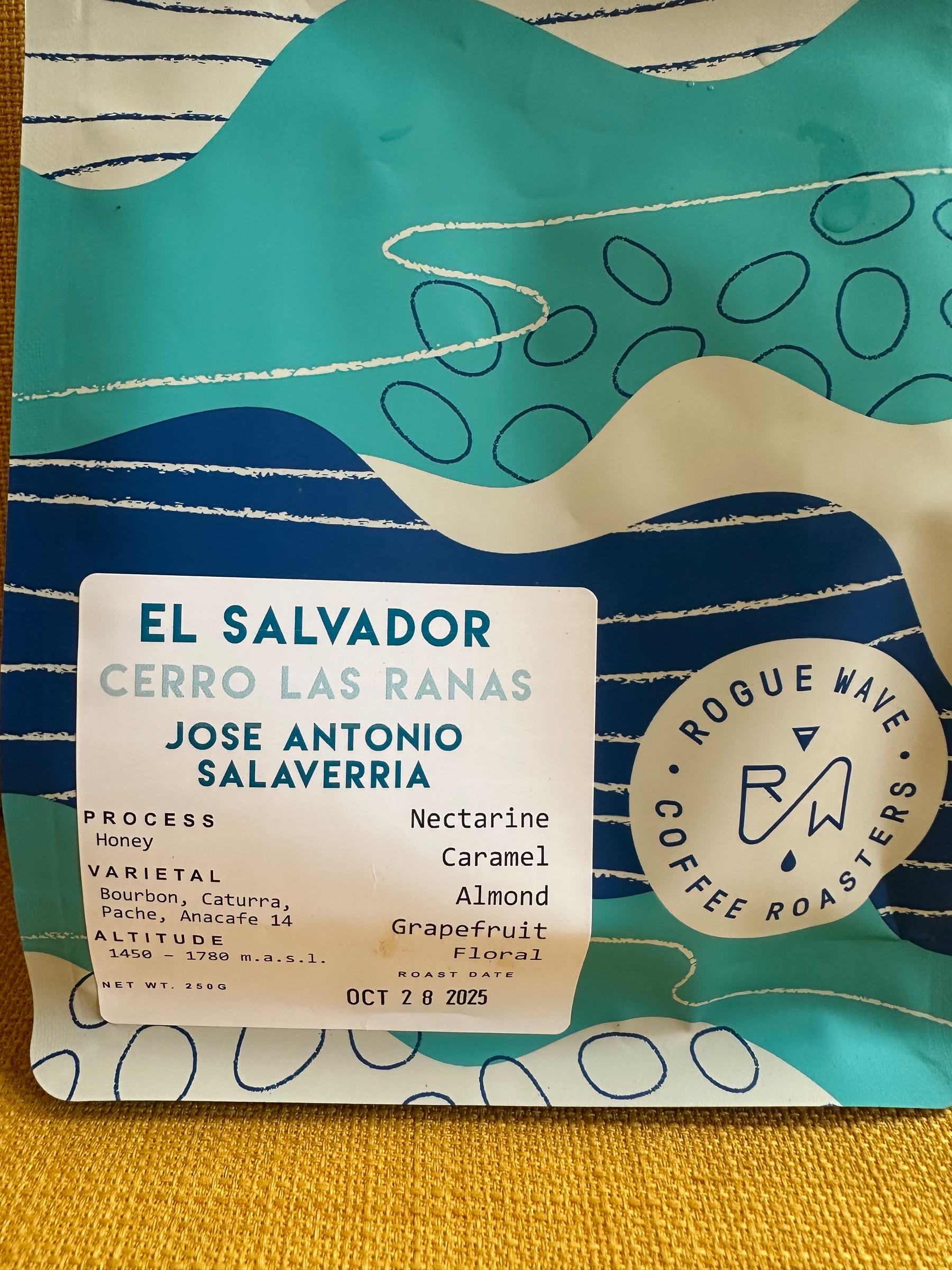 A bag of Rogue Wave Coffee Roasters featuring coffee details, including an El Salvador origin, honey process, and flavor notes like nectarine, almond, grapefruit, floral and caramel.
