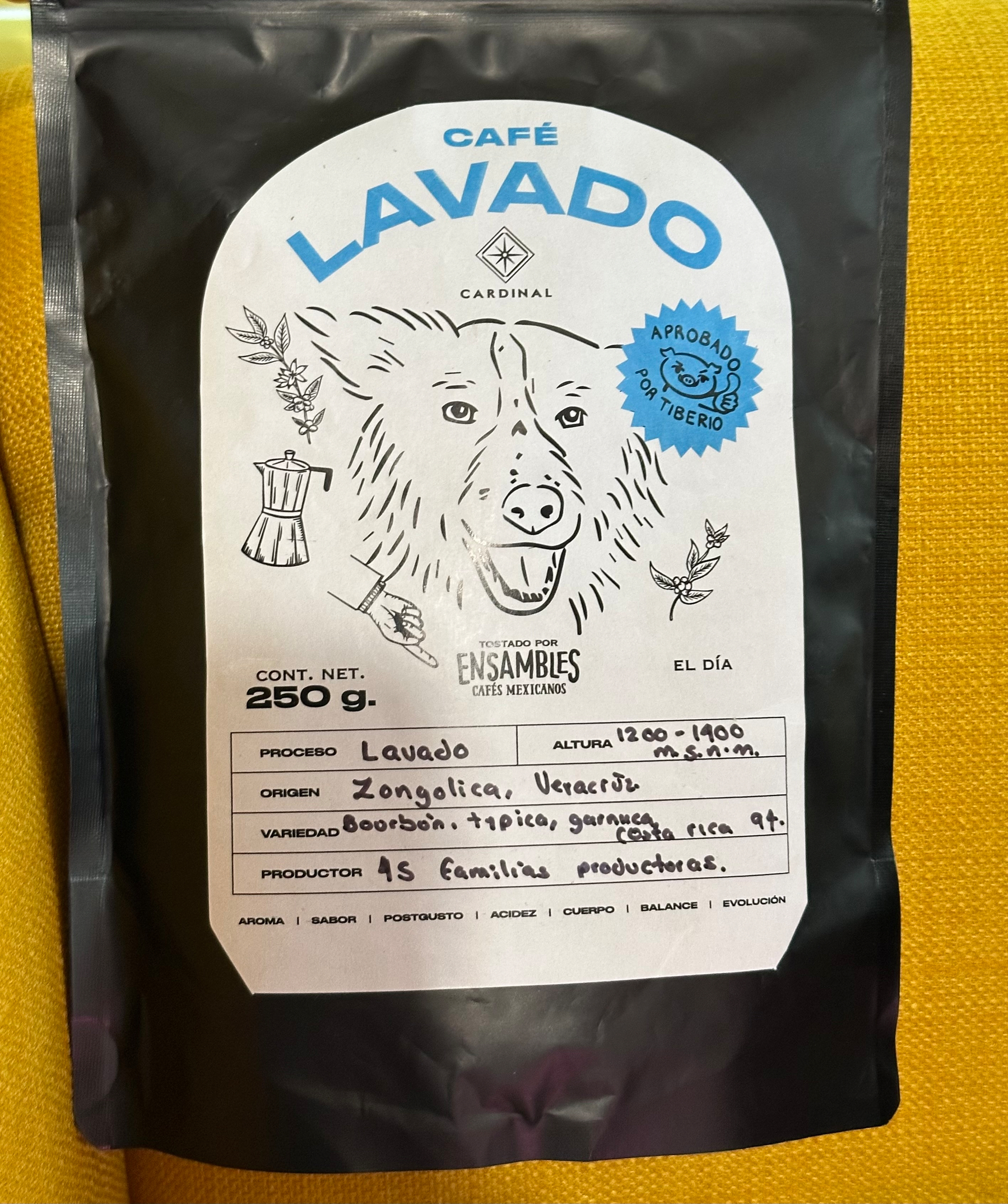 A coffee package labeled Café Lavado features a line-drawn dog illustration, details about the coffee's origin in Zongolica, Veracruz, and information on the variety and producer.